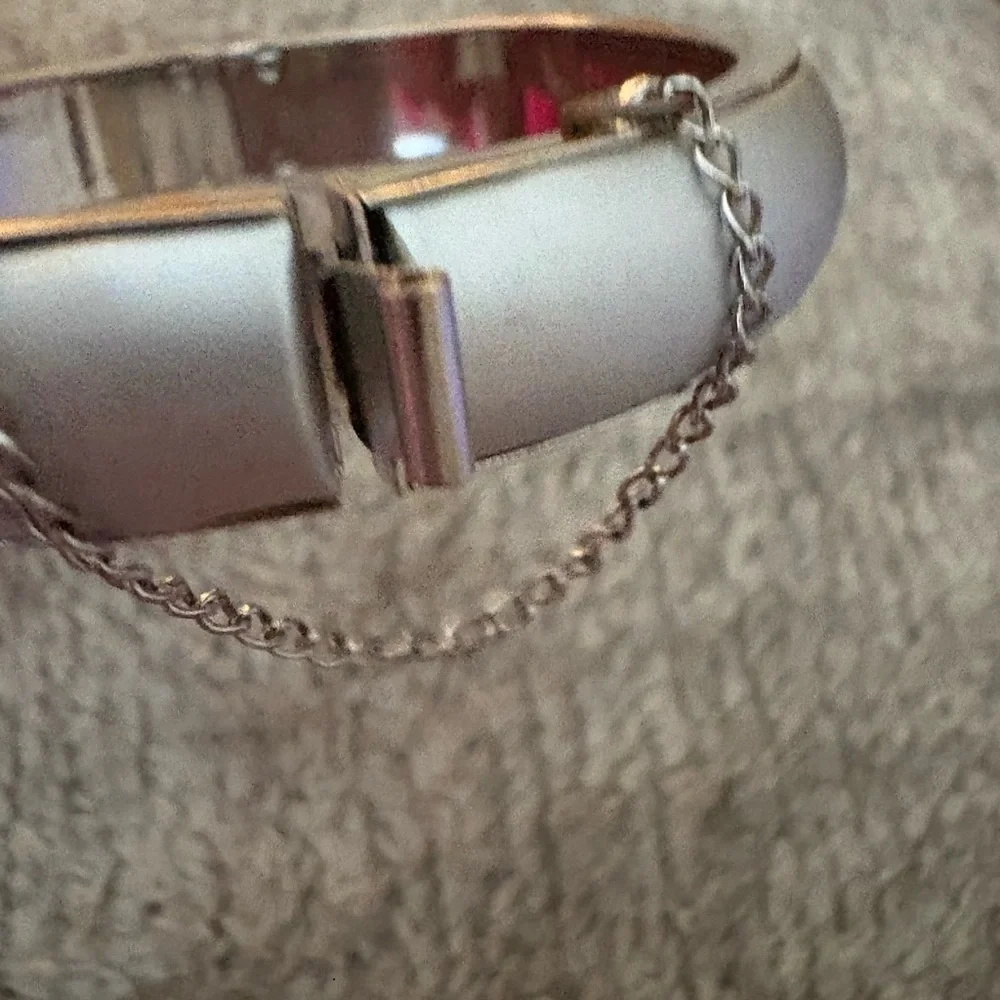 GUC silver tone bangle with safety chain